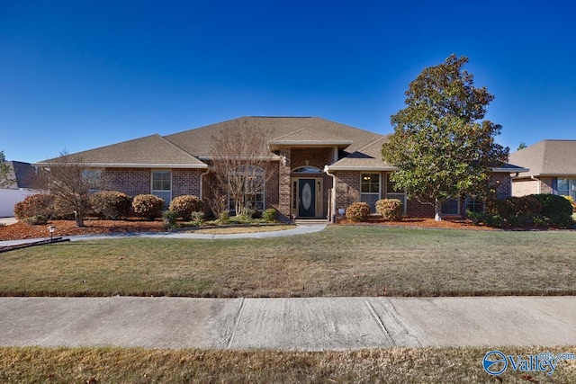 ranch-style home with a front lawn