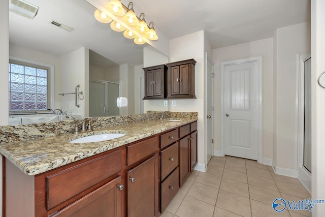 bathroom with tile patterned flooring, vanity, and an enclosed shower