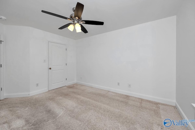 empty room featuring light colored carpet and ceiling fan