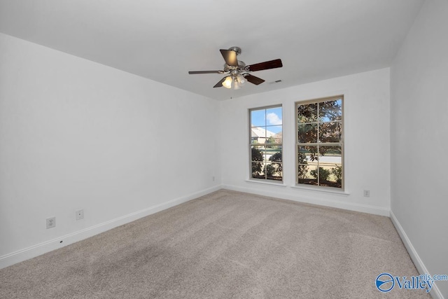 spare room featuring carpet and ceiling fan