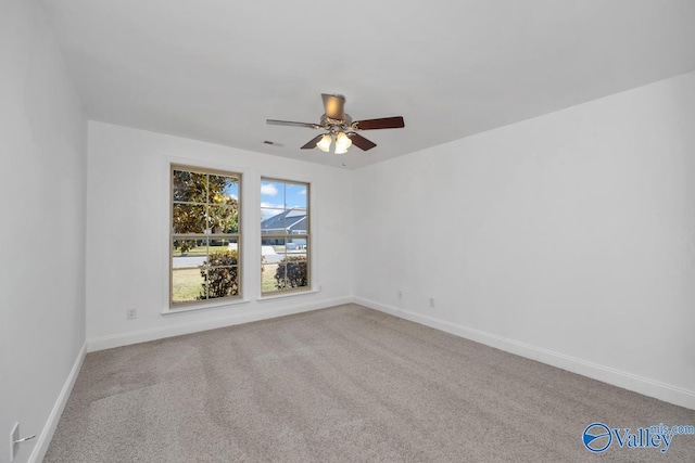 unfurnished room featuring ceiling fan and carpet floors