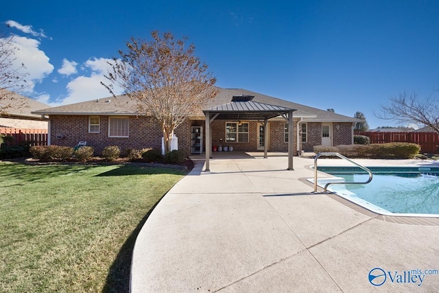 back of house with a lawn, a patio, a fenced in pool, and a gazebo