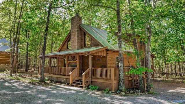 log home featuring a porch