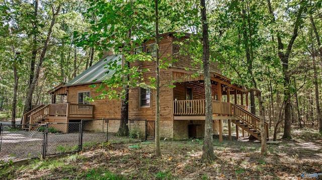 rear view of property with a wooden deck