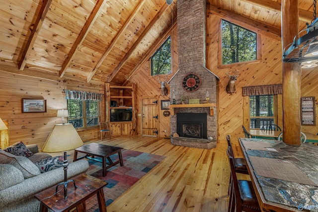 living room with a healthy amount of sunlight, hardwood / wood-style flooring, and wooden walls