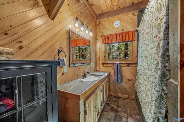 bathroom featuring vanity, wooden walls, lofted ceiling with beams, and wood ceiling