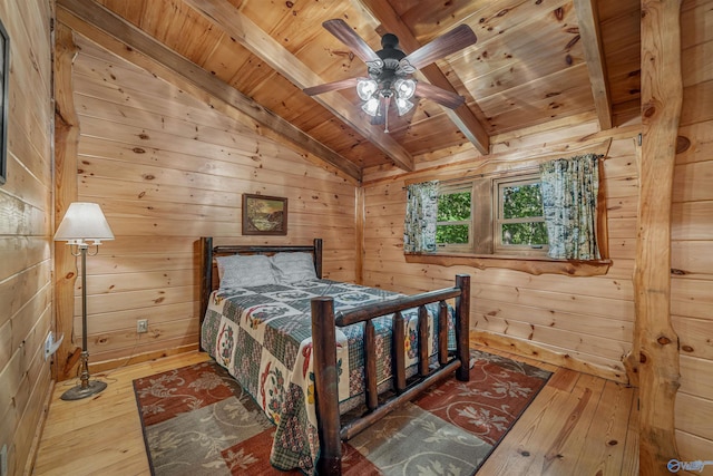 bedroom with hardwood / wood-style floors, ceiling fan, wood ceiling, and wood walls