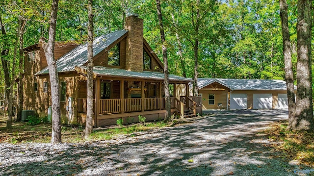 log home with a porch, central AC, and a garage