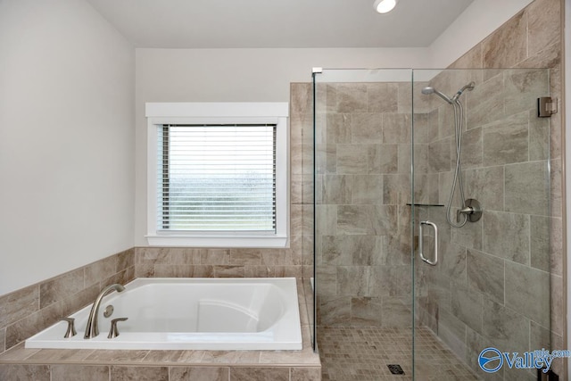 bathroom featuring separate shower and tub