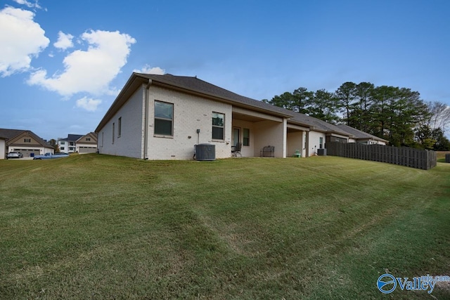 rear view of house with a yard