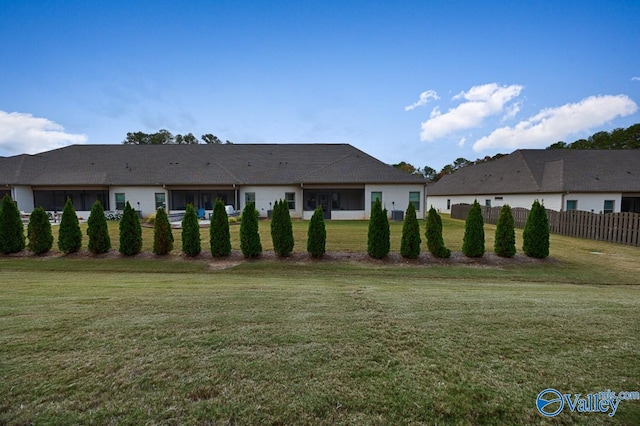 back of property featuring a yard