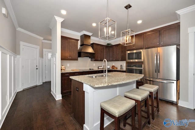 kitchen with custom exhaust hood, a center island with sink, appliances with stainless steel finishes, dark wood-type flooring, and sink