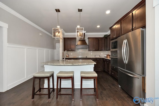 kitchen with pendant lighting, a kitchen island with sink, stainless steel appliances, and dark hardwood / wood-style floors