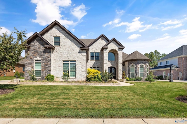 french provincial home with a front yard