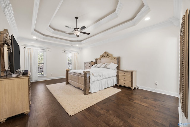 bedroom with a tray ceiling, ceiling fan, dark wood-type flooring, and crown molding