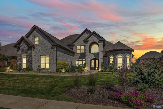 french provincial home featuring a yard