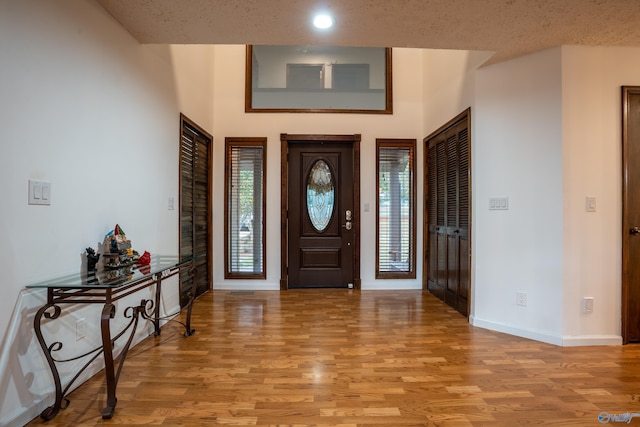 foyer entrance featuring light wood-type flooring and a textured ceiling