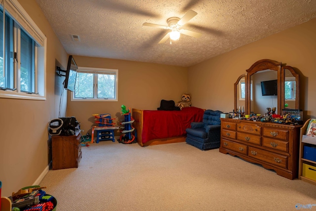 interior space with a textured ceiling and ceiling fan