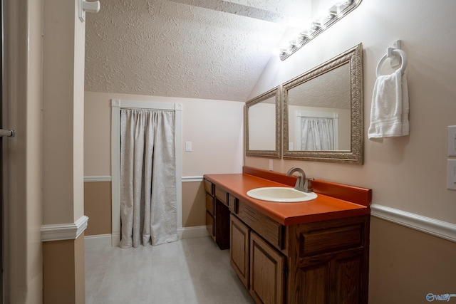 bathroom featuring lofted ceiling and vanity