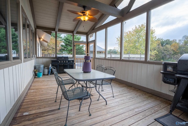 sunroom featuring vaulted ceiling with beams and ceiling fan