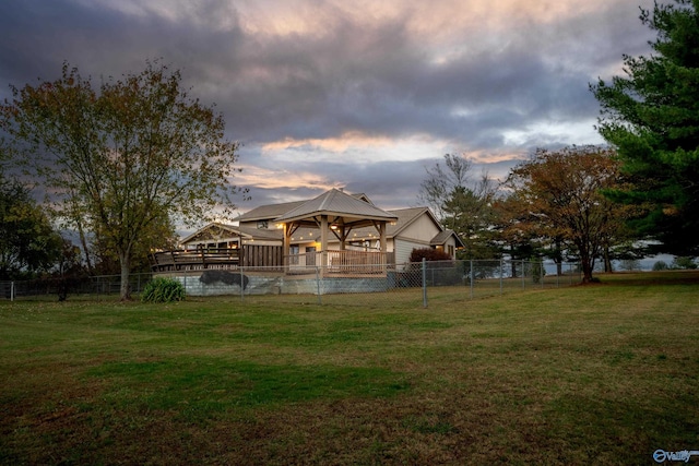 yard at dusk featuring a gazebo