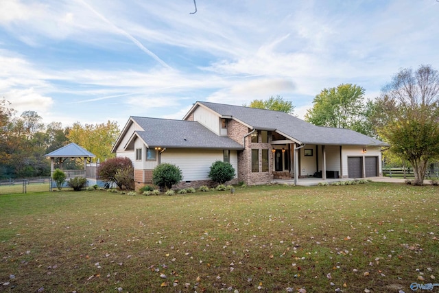 view of front of house with a front lawn and a garage