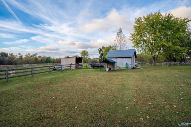 view of yard featuring a rural view and an outbuilding