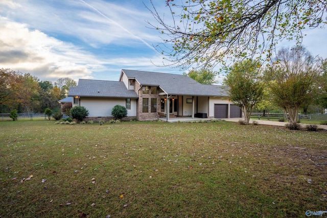 view of front of property with a garage and a front lawn