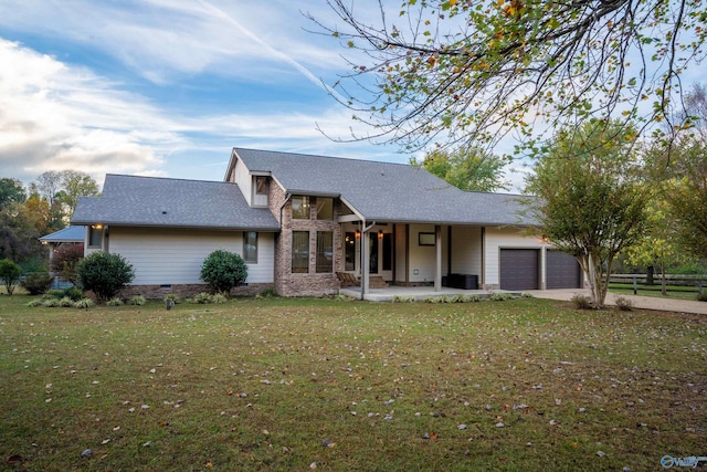 view of front of house with a garage and a front lawn