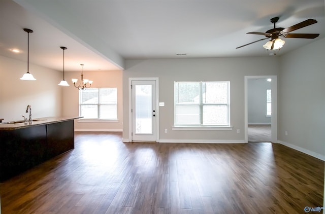 kitchen with ceiling fan with notable chandelier, decorative light fixtures, dark hardwood / wood-style flooring, and sink