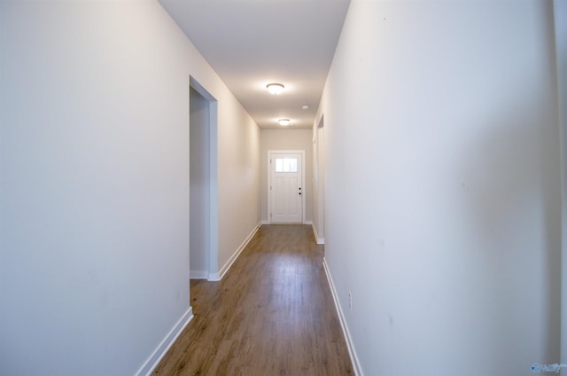 hallway with light hardwood / wood-style floors