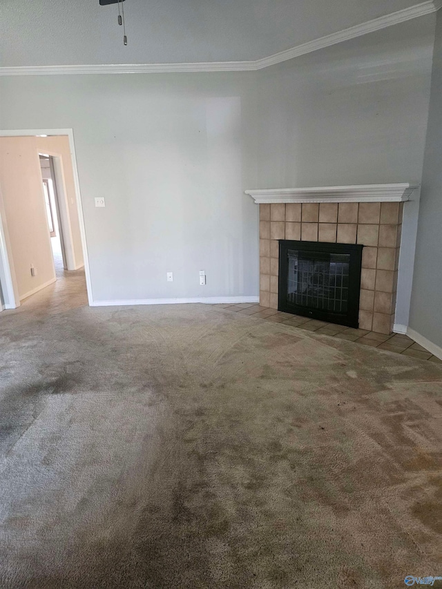 unfurnished living room with a fireplace, ornamental molding, and carpet