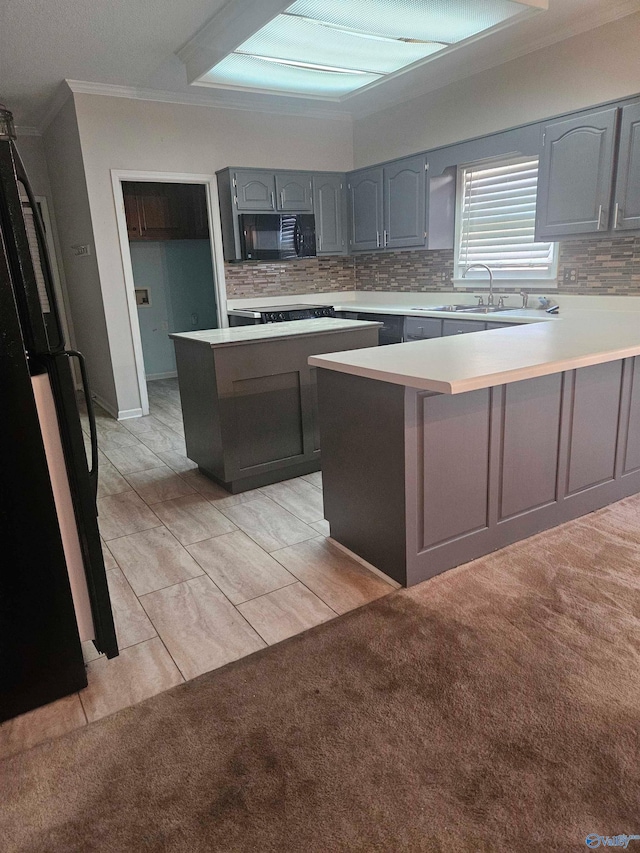 kitchen featuring sink, crown molding, black appliances, light colored carpet, and kitchen peninsula