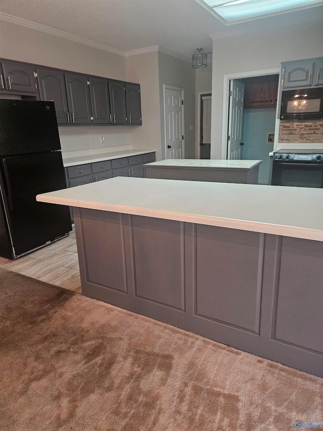 kitchen featuring light colored carpet, ornamental molding, and black appliances