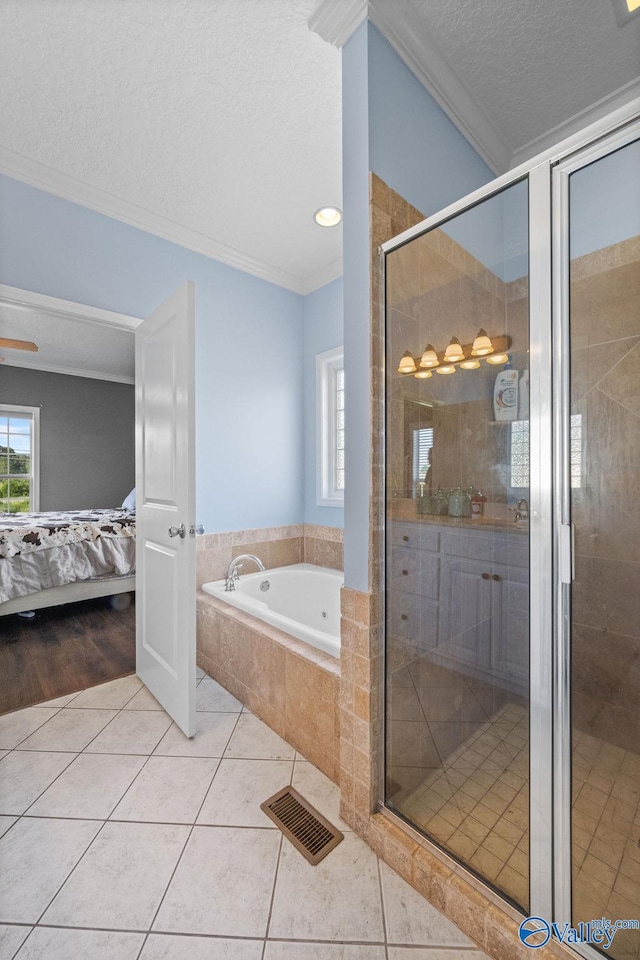 bathroom featuring tile patterned flooring, crown molding, a textured ceiling, and separate shower and tub