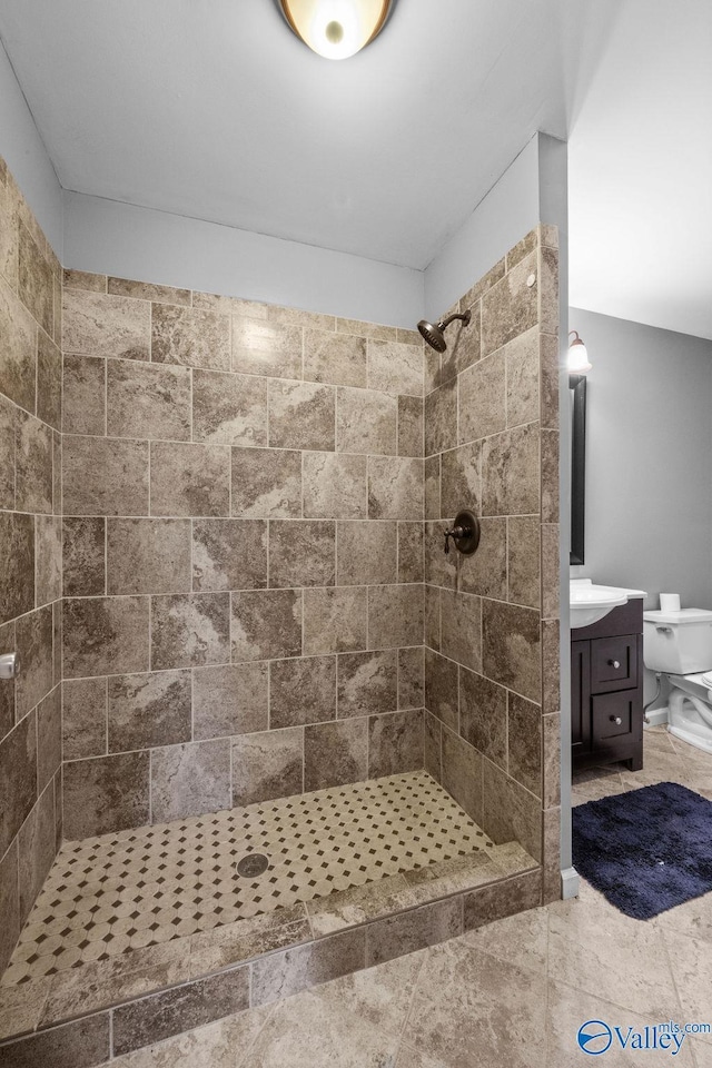 bathroom featuring vanity and a tile shower