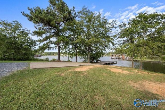 view of yard with a dock and a water view