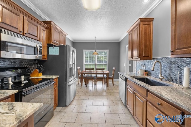 kitchen with tasteful backsplash, light stone countertops, stainless steel appliances, and sink