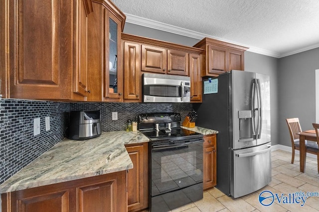 kitchen featuring crown molding, appliances with stainless steel finishes, and backsplash