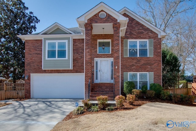 view of front of house with an attached garage, fence, concrete driveway, and brick siding