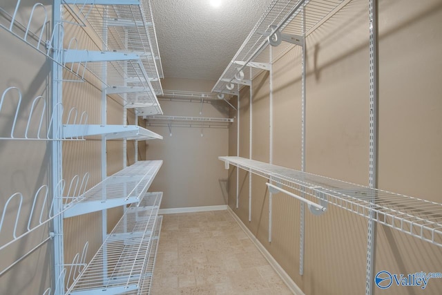 spacious closet with stone finish flooring