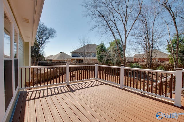 wooden terrace featuring fence