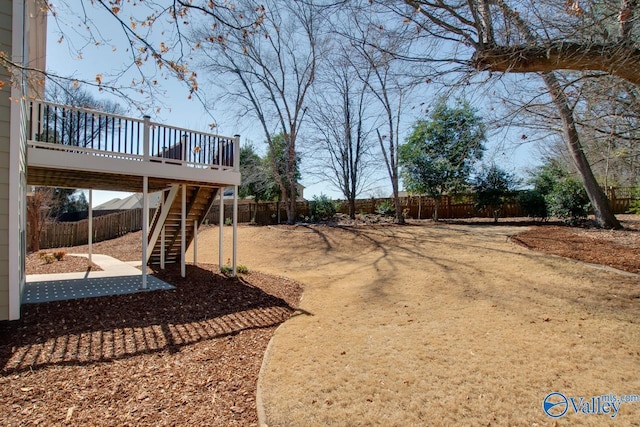 view of yard with stairway, fence private yard, and a wooden deck