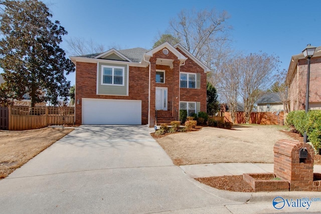 view of front of home with a garage, brick siding, fence, and driveway