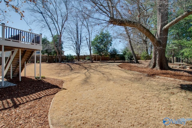 view of yard featuring stairway, fence, and a wooden deck