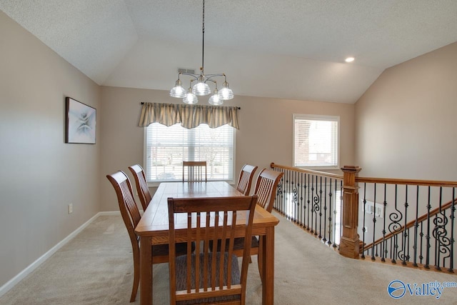 dining area featuring a wealth of natural light, vaulted ceiling, light colored carpet, and a notable chandelier