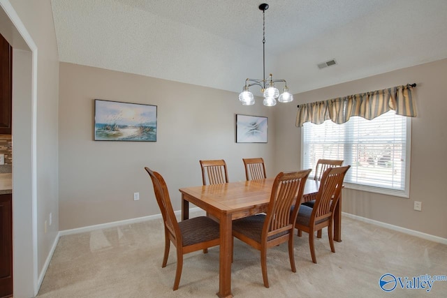 dining space with light carpet, visible vents, baseboards, and an inviting chandelier