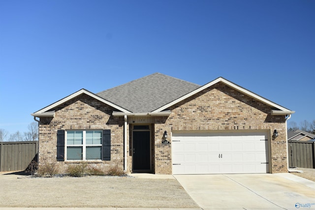 ranch-style home with concrete driveway, brick siding, an attached garage, and fence