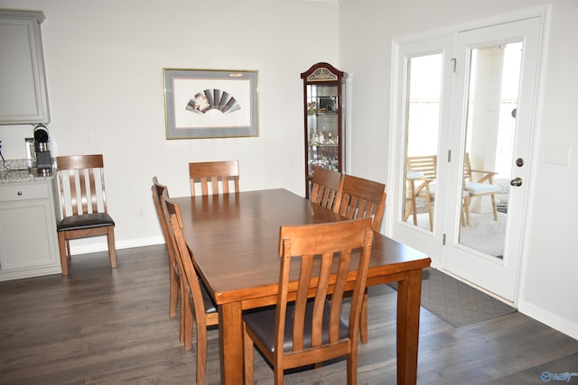 dining room featuring a healthy amount of sunlight, baseboards, and dark wood finished floors