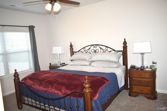 carpeted bedroom featuring ceiling fan and baseboards